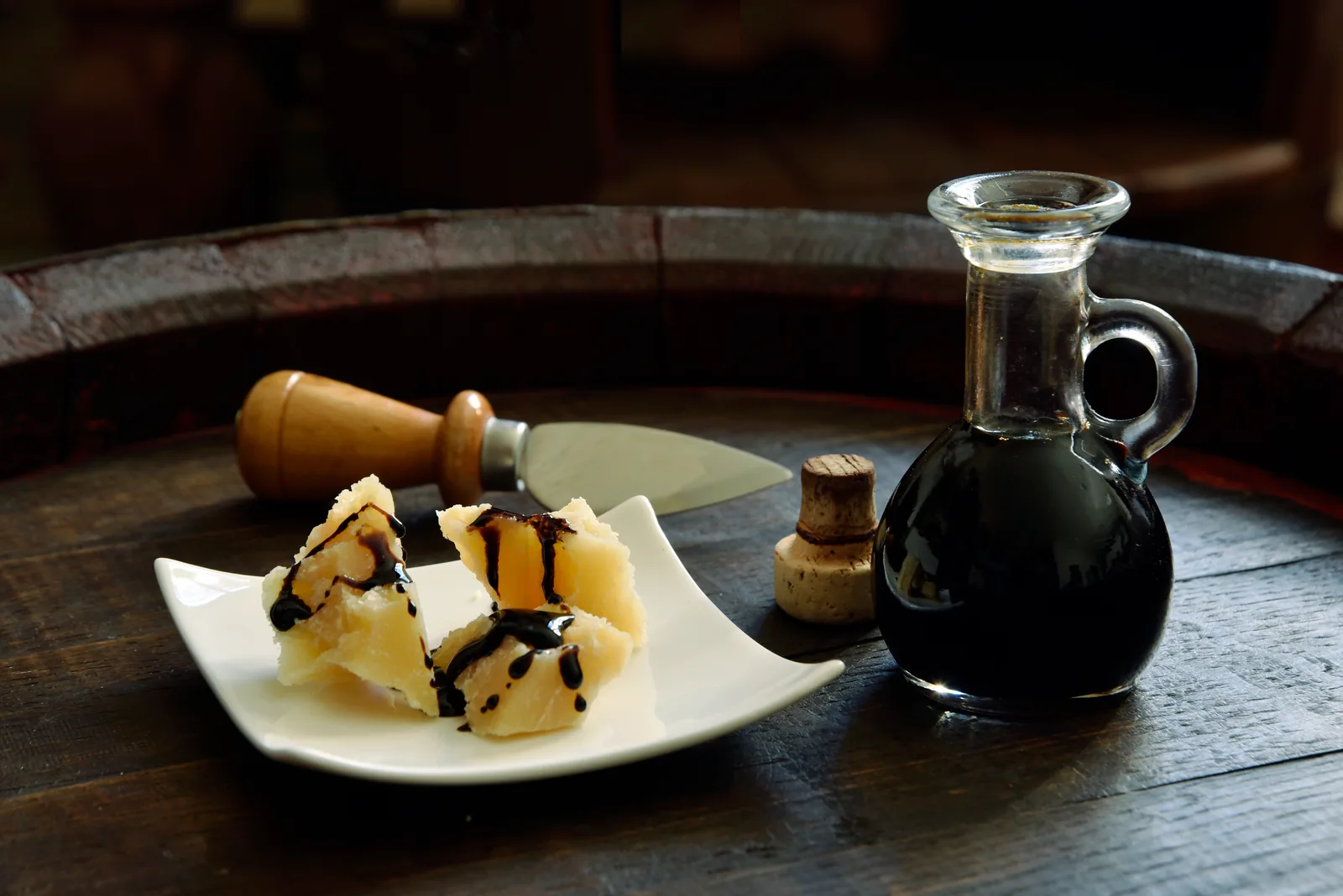 Aged balsamic vinegar of Modena drizzled on Parmigiano Reggiano