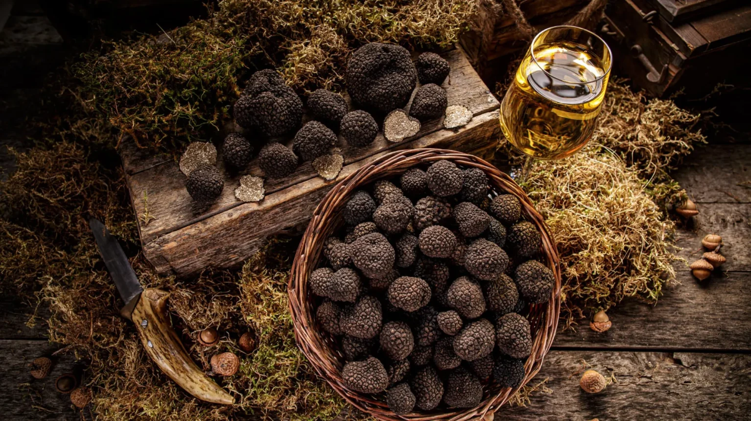 A basket of truffles with a bottle of wine