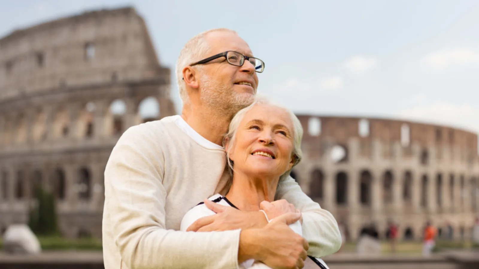Senior couple embracing in front of the Colosseum in Rome